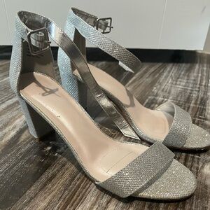 Silver, glitter heels that are perfect for a wedding or dressing up an outfit.